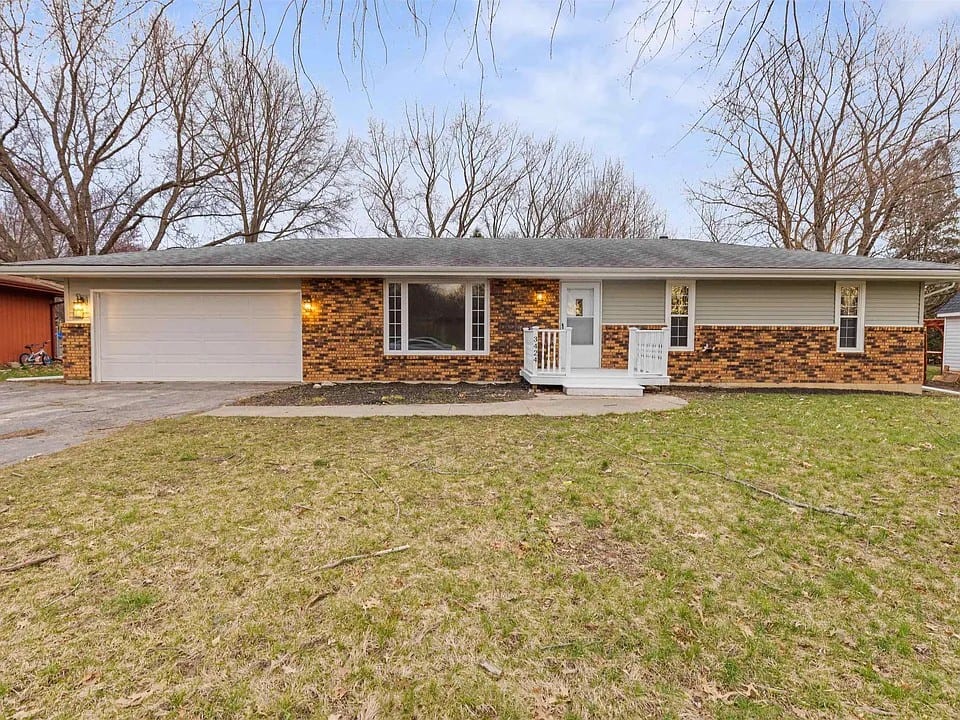 3424 Cavendish Drive, Rockford: a single-storey brick and vinyl ranch with an attached two-car garage and a white-railed front stoop.